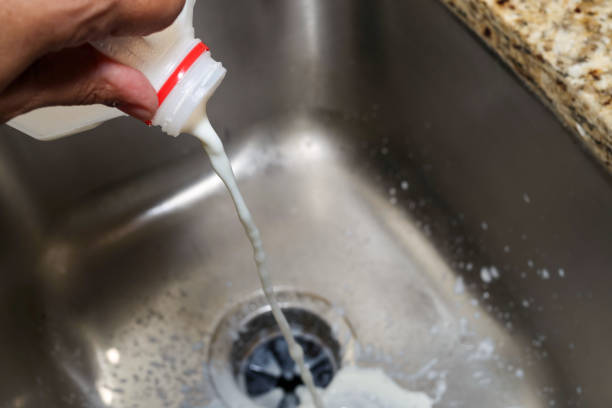 istock pouring spoiled milk into a kitchen sink 2167607578