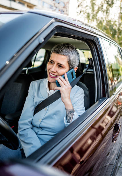 istock Businesswoman having phone call while sitting in a car 2167608321