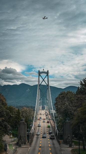 Lion's Gate Bridge with Seaplane Flying Above