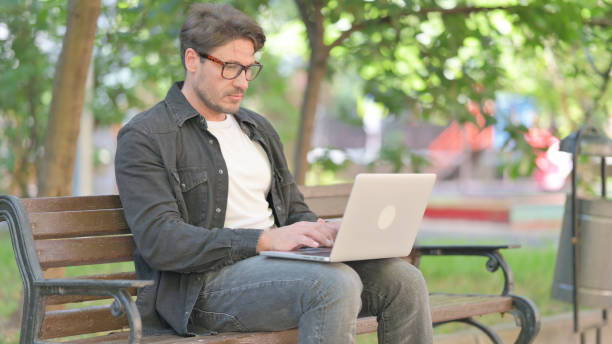 istock Middle Aged Man Working on Laptop Outdoor 2167613128