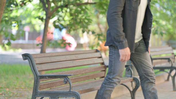 Middle Aged Man Leaving Bench in Park