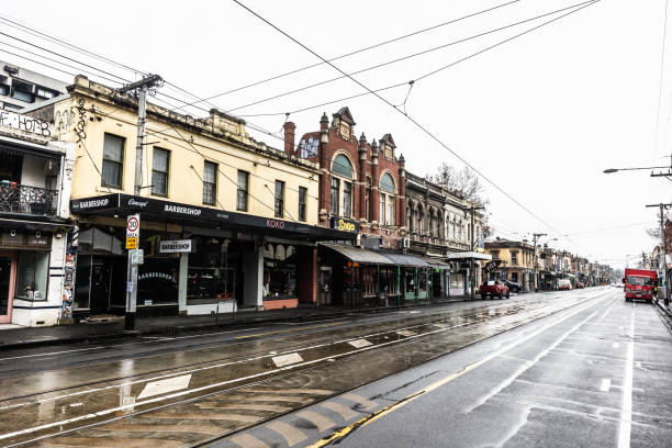 MELBOURNE, AUSTRALIA - JULY 29, 2024: The famous and popular shopping street of Brunswick St on a wet winter's day in Fitzroy, Victoria, Australia
