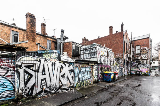 An urban alleyway bursts with color, showcasing diverse graffiti and street art murals. A vibrant expression of city culture and creativity. London, UK, 5 November 2023