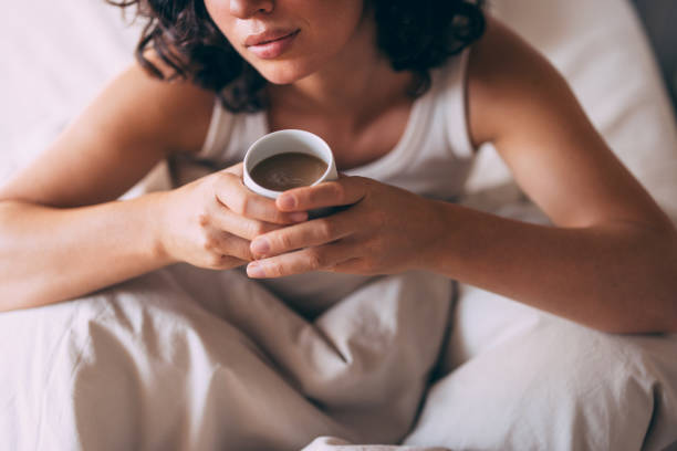 istock Relaxed Morning in Bed with Coffee in Hand 2167617372