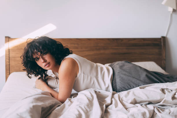 istock Woman Relaxing in Bed with Soft Morning Light 2167617393