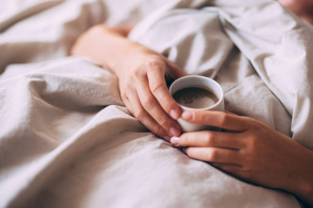 Relaxing Morning in Bed with a Warm Cup of Coffee