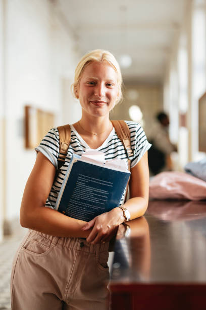 istock Confident University Student Standing in a Bright Hallway 2167617581
