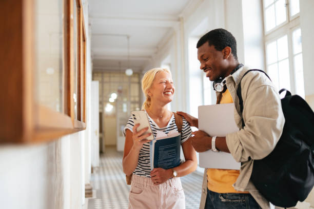 istock University Students Laughing and Engaging in a Bright Hallway 2167617618