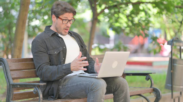 istock Middle Aged Man with Loss on Laptop Outdoor 2167617929