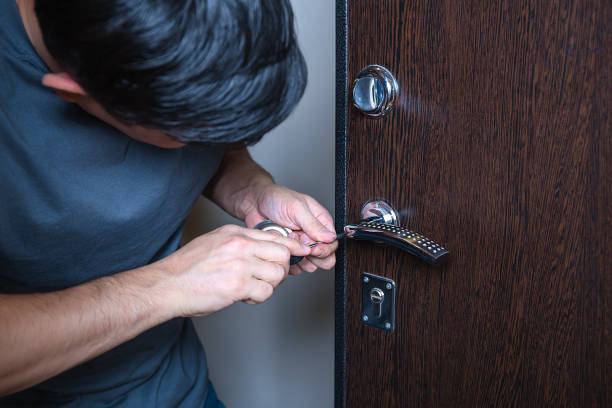 istock Locksmith replacing door lock to new after losing keys. Robbery protection, safety improvement. Repairman or workman changing or repair door lock. 2167619621