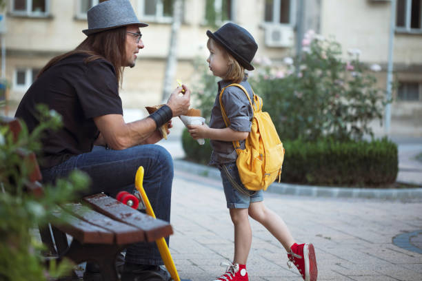 istock Middle-aged father and his cute kid create priceless moments together while eating ice cream outside 2167619717