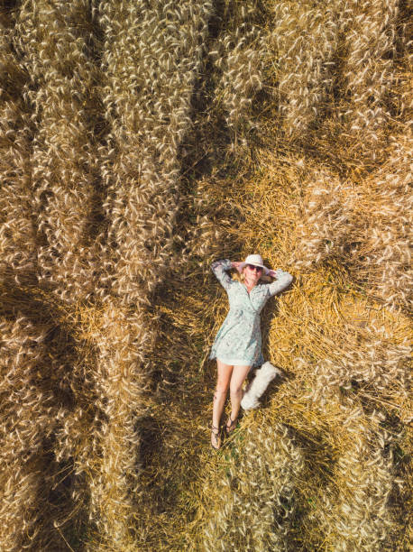 Beautiful woman relaxing in wheat field