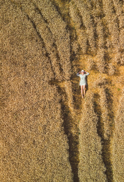 istock Beautiful woman relaxing in wheat field 2167619848