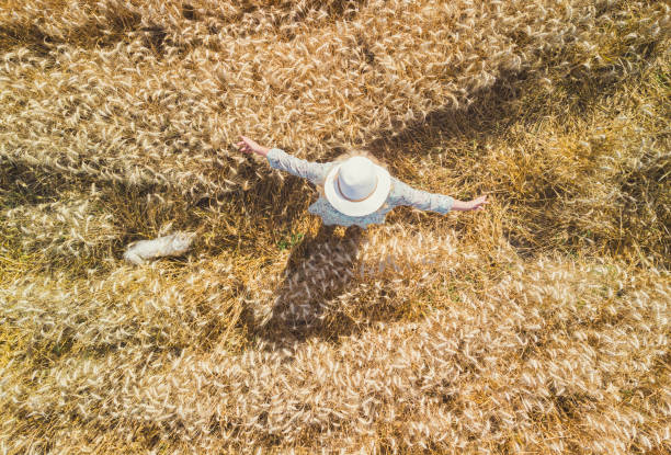 istock Woman walking through a wheat field 2167619860