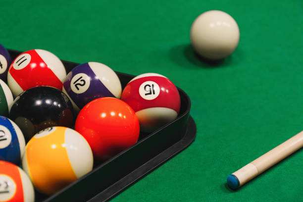 istock Colorful billiard balls with numbers with cue sticks and rack on blue table 2167624179