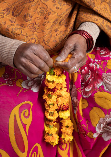 istock India, Hardiwar, woman making religious garlands 2167625864