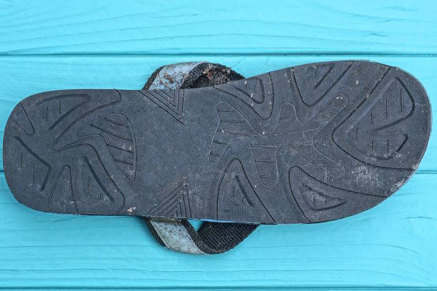 istock black sandal sole lies on a blue wooden table 2167629145