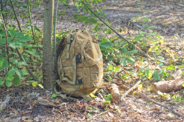 istock one big full brown army backpack stands on the ground 2167629322