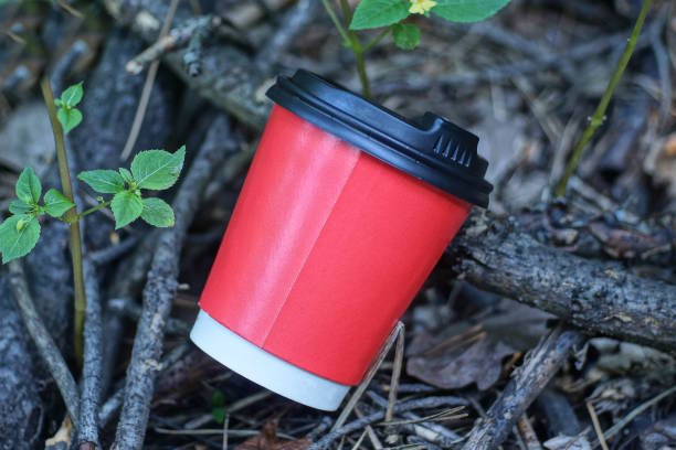 istock one red paper cup covered with a black lid lies on the ground 2167629546