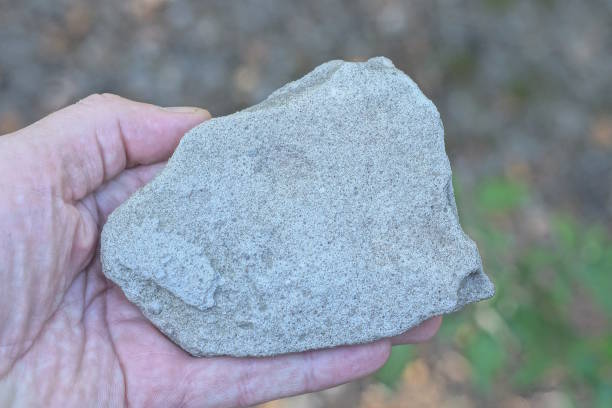 istock a man hand holds a large white piece of stone brick 2167629630