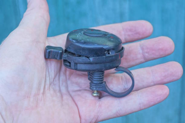 istock one old black broken plastic bicycle bell lies on palm on street 2167629928