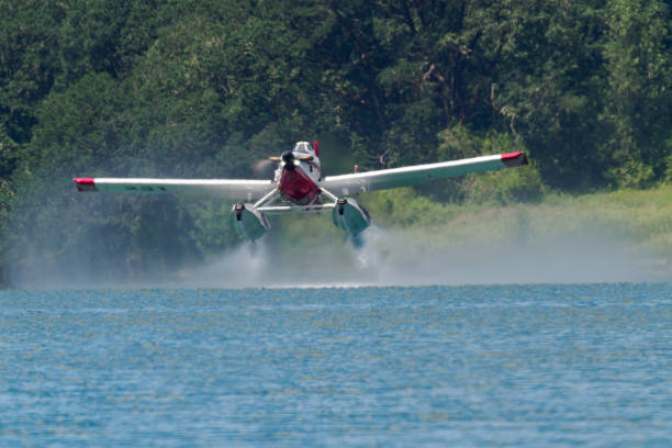 Gaston, Oregon, USA - July 02, 2024: Two AT-802F Fire Boss amphibious scooper air tankers were training this day at Henry Hagg Lake. Along with the aircraft were firefighters on the ground assisting in the water drop. The aircraft make a loop, scooping water from the lake, going to the drop zone assisted by firefighter communication and fly back for another 800 gallon load of water. This picture shows the airplane as it is leaving the water. Henry Hagg Lake is located about  25 miles southwest of Portland, Oregon.