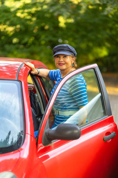 istock A woman in a striped shirt and blue hat smiles while standing next 2167631941