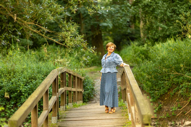 istock A woman in a blue blouse and patterned skirt stands on a rustic 2167632129