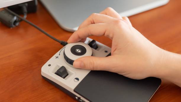 istock A woman uses a special magnification device for the visually impaired. 2167641116