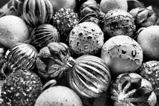 istock New Year's Christmas balls and decorations close up surface. Monochrome black white silver. Striped modern Christmas balls. Festive beautiful background. Design xmas. Decorating home winter holidays 2167641355