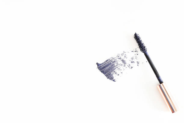 Eyelash mascara applicator with dark blue brush strock on white background. Cosmetic makeup swatch .