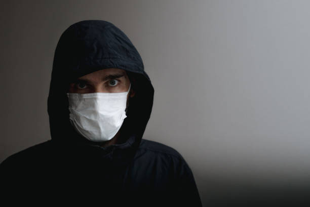 istock A Caucasian man dressed in black with a hood over his head 2167641904