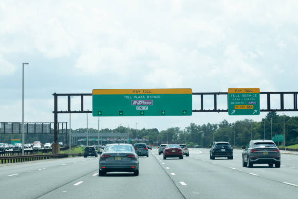 Woodbridge, New Jersey - August 18, 2024: Cars drive toward the EZ Pass toll plaza bypass on the Garden State Parkway Southbound