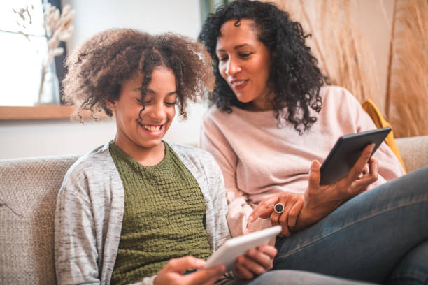 istock Technology and Togetherness: Hispanic Mother and Mixed Race Daughter 2167645136