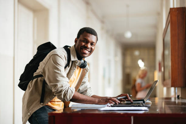 istock Happy University Student Working on Laptop in Hallway 2167655076