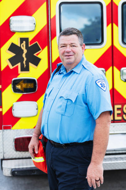 istock Paramedic standing outside fire rescue ambulance 2167656690