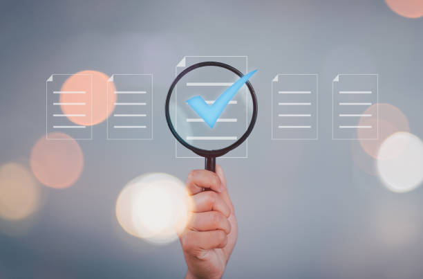 istock Hand holding magnifier glass with virtual paper document and correct tick sign mark for prepare check and approve of quality assurance concept. 2167660198