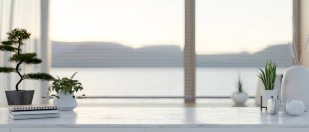 istock A modern white marble table in a contemporary room with a large window. 2167663649