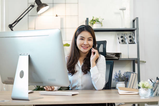istock Professional Call Center Agent Working at Desk in Modern Office Environment with Headset and Computer 2167665800