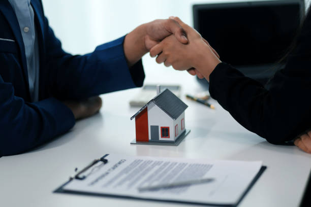 istock Estate agent shaking hands with customer after contract signature 2167669548