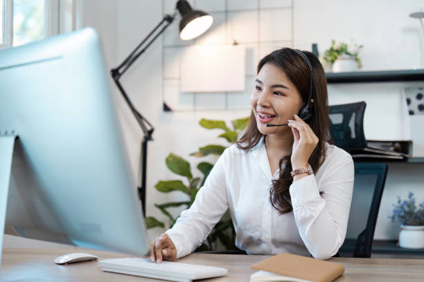 istock Professional Call Center Agent Working at Desk with Headset in Modern Office Environment 2167669594