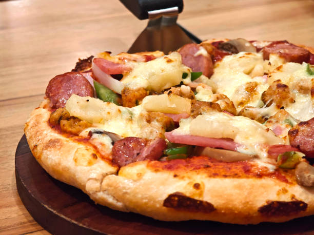 istock Super deluxe pizza on wooden plate 2167673140