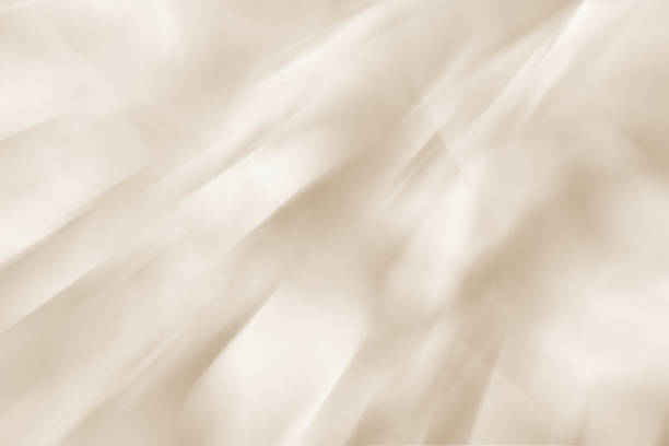 Shiny silky light beige drape background. Texture with an elegant and luxurious atmosphere