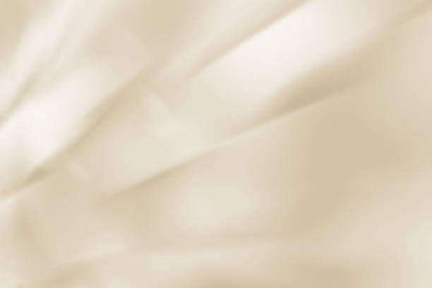 istock Shiny silky light beige drape background. Texture with an elegant and luxurious atmosphere 2167677609