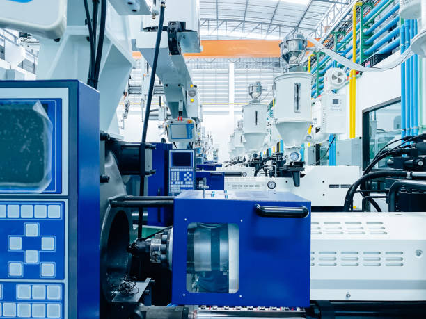 istock High-tech plastic injection molding machines lined up in a modern factory. 2167683138