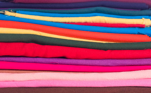 istock Group of many colorful cotton fabrics stacked background 2167684585