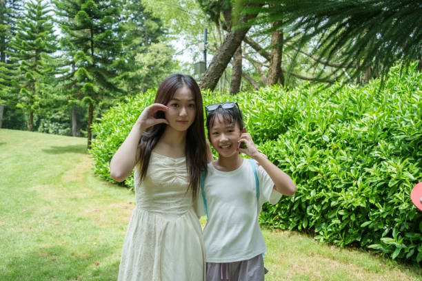A pair of Asian sisters in the park