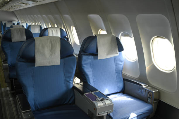 istock Row of empty airplane seats with natural sunlight streaming through the windows 2167688397
