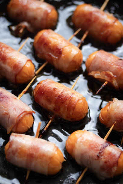 istock Fried Bacon Wrapped Pork Sausages On Frying Pan 2167696787