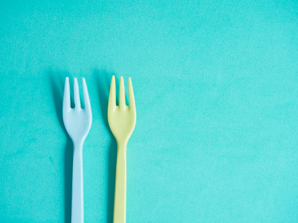 istock Two colorful plastic forks on turquoise background top view with copy space. Eating concept. 2167697669